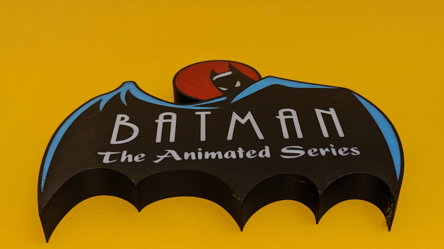 Batman logo from 'The Animated Series' on a yellow background