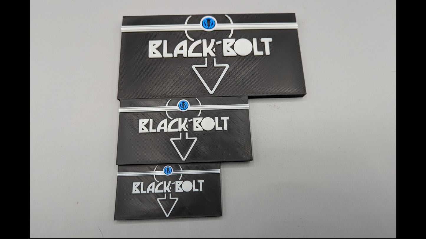Three black 'Black Bolt' packages stacked on a gray surface