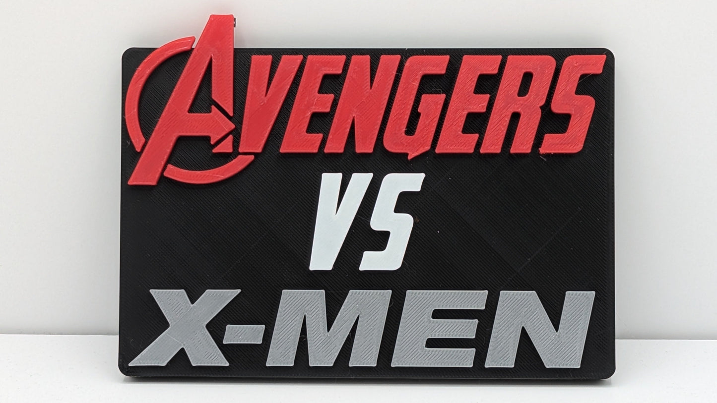 Plaque with 'Avengers vs X-Men' text on a white background