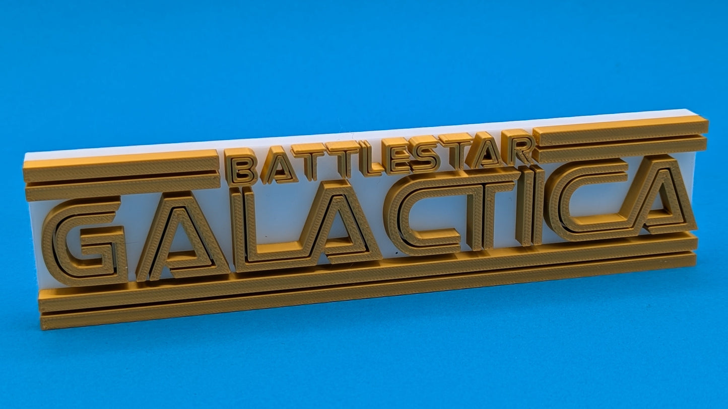 Metallic 'Battletear Galactica' logo on a blue background