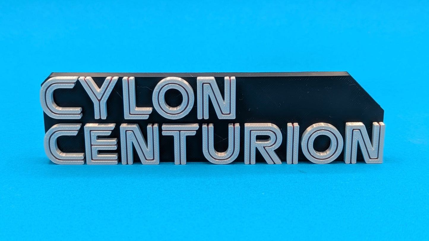 Metallic 'Cylon Centurion' badge on a blue background
