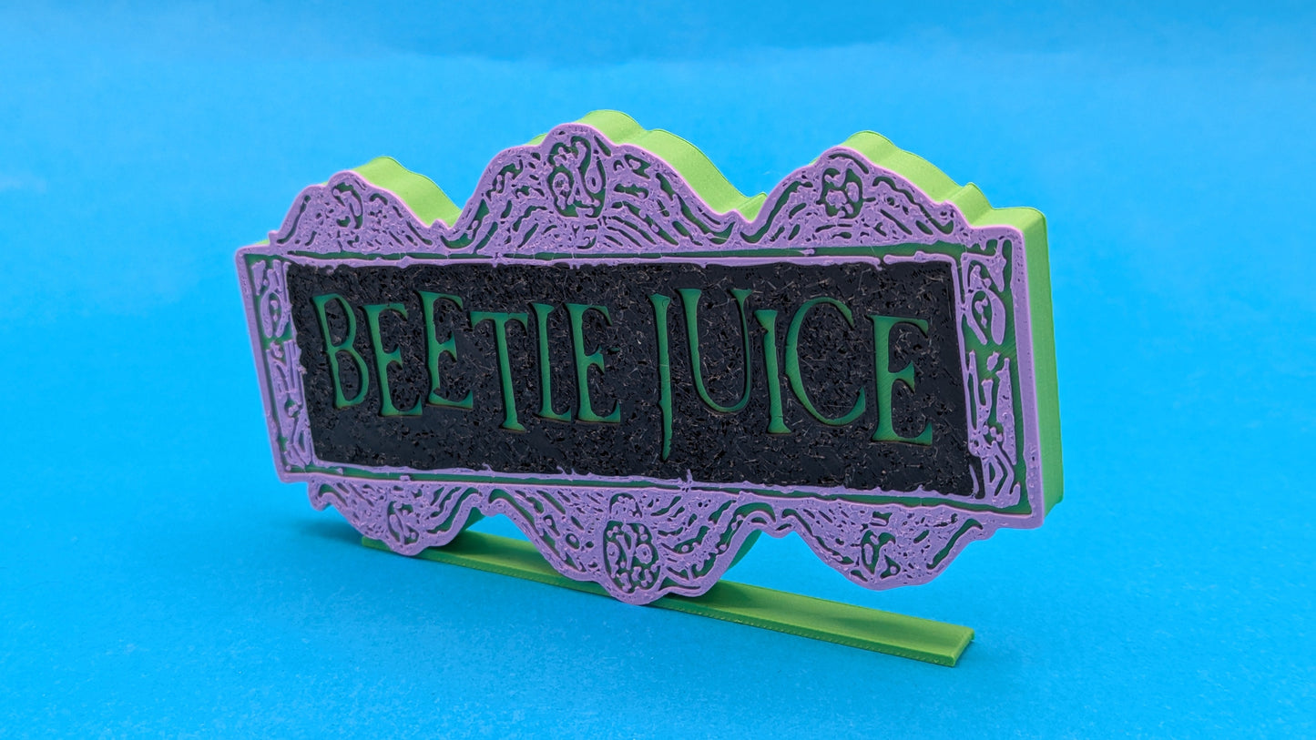 Decorative sign with 'Beetle Juice' text on a blue background