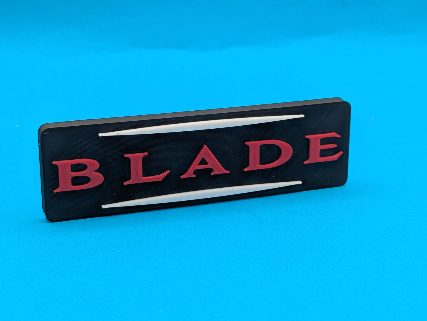 Black and red 'BLADE' logo on a blue background