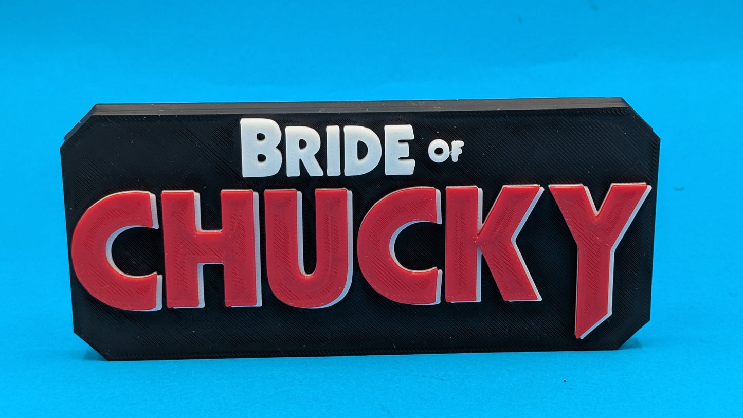 Decorative sign with 'Bride of Chucky' text on a blue background
