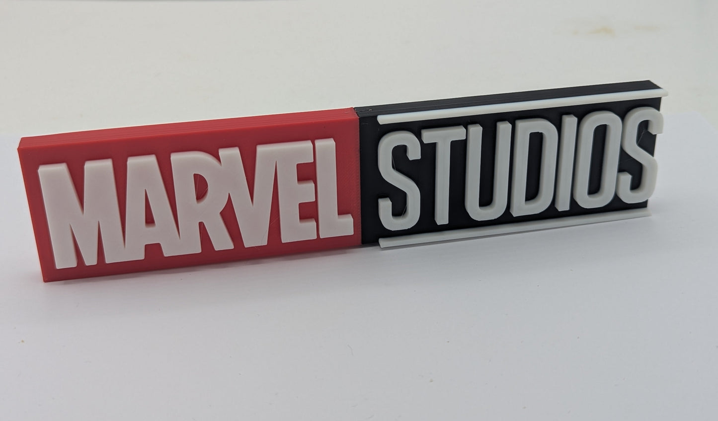 Marvel Studios logo on a red and black rectangular sign