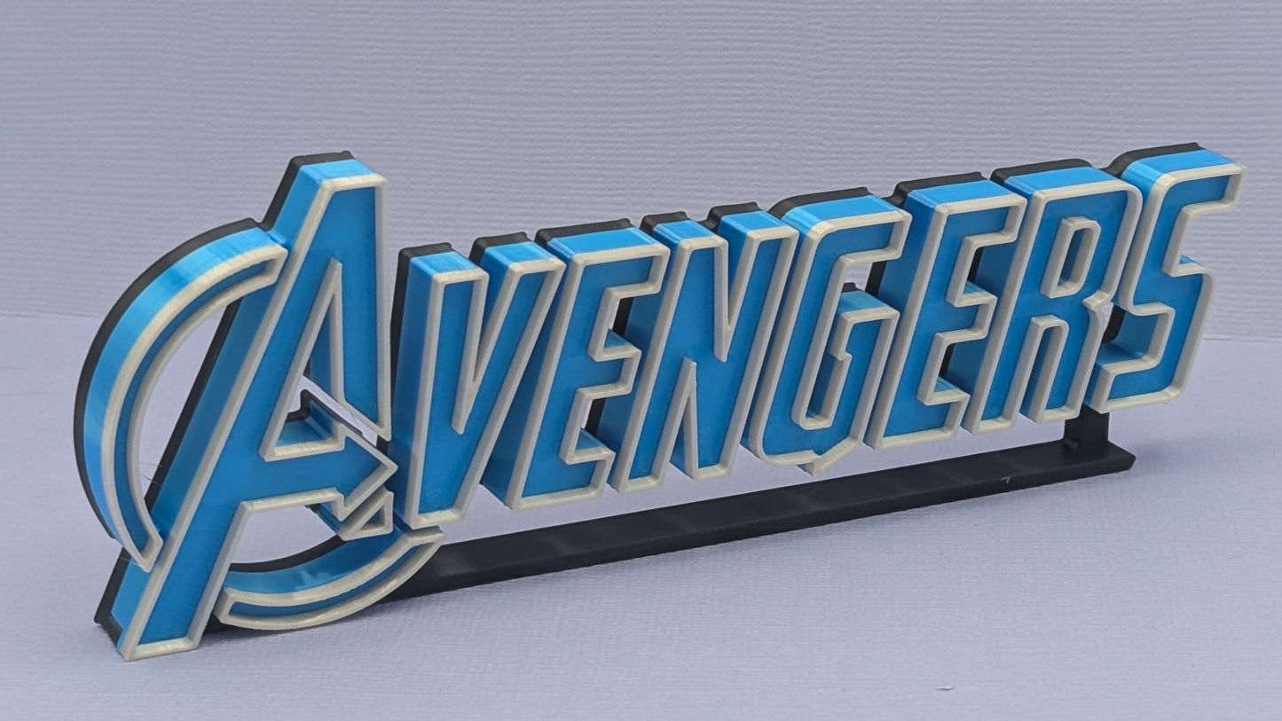 3D metal emblem with 'Avengers' text on a gray background