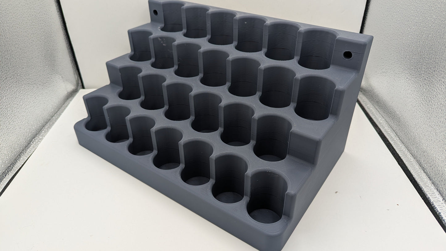 Gray silicone ice cube tray on a white surface with a neutral background