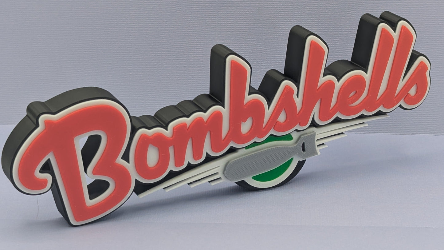 Decorative sign with 'Bombshells' text and rocket graphic on a gray background