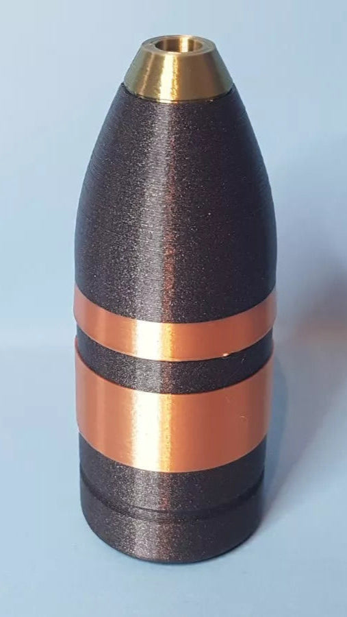 Metallic cylindrical object with gold and bronze accents on a light blue background