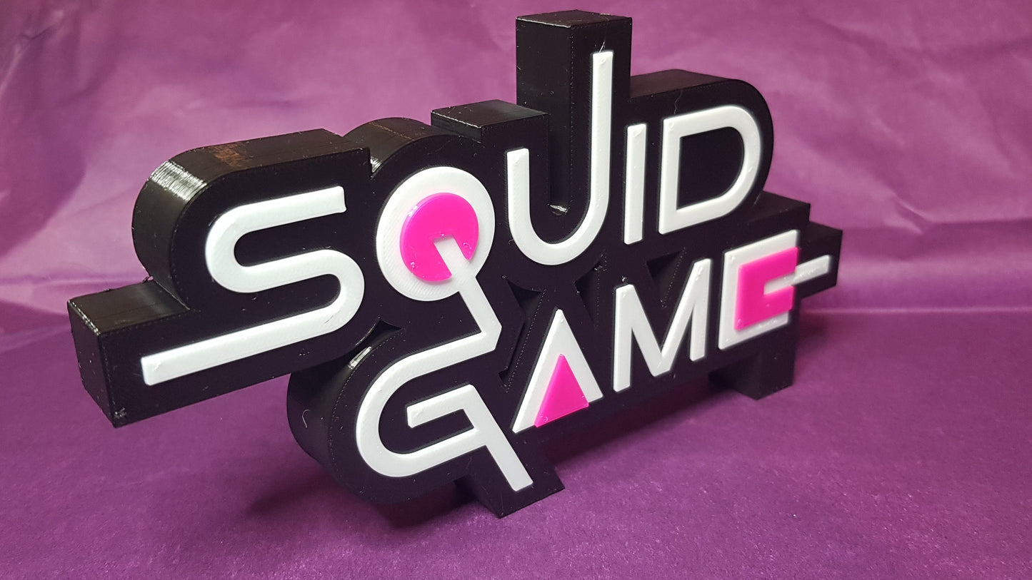 Sculpted 'Squid Game' logo on a purple background