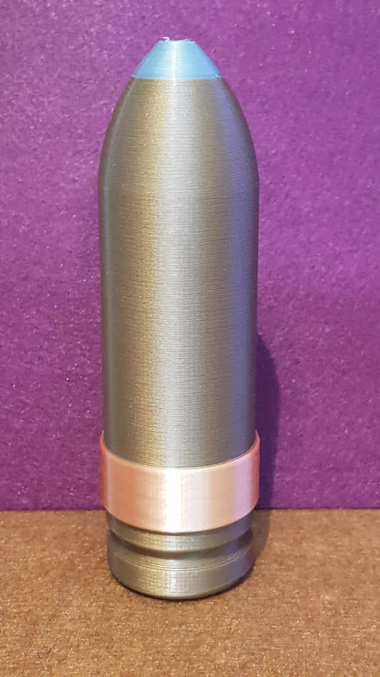 Metallic bullet-shaped object on a purple and brown background