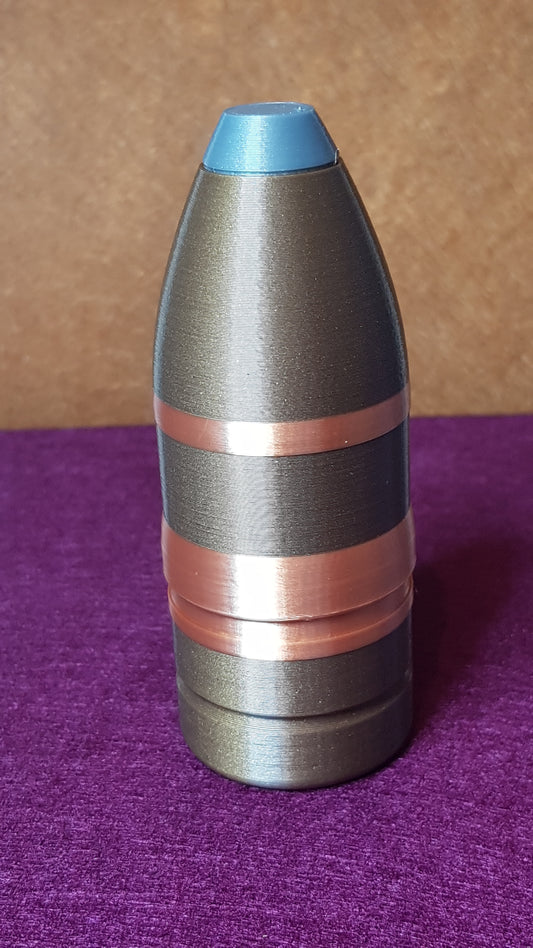 Close-up of a metallic cylindrical object with colored bands on a brown and purple background