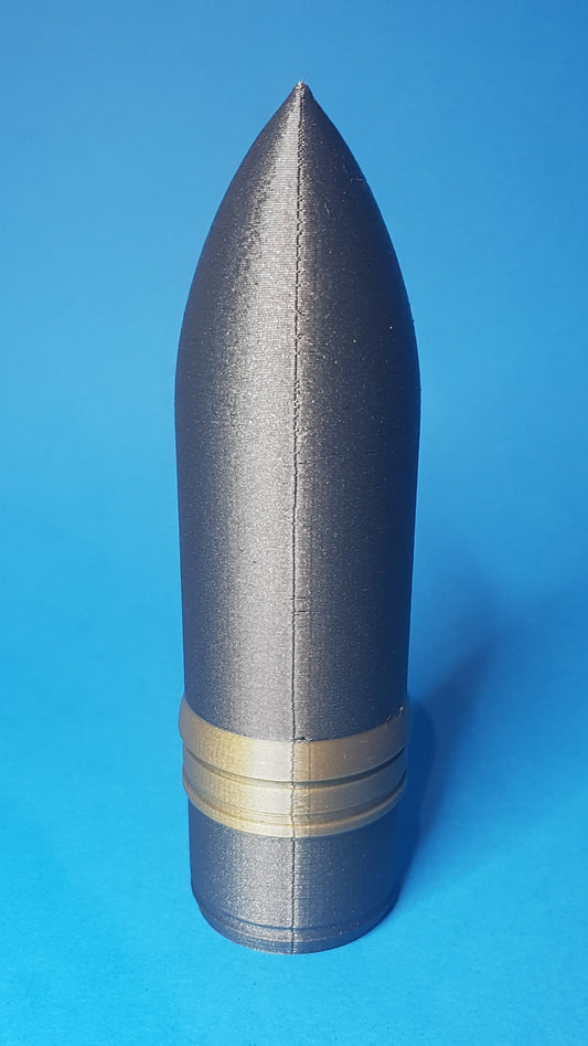 Gray cylindrical object with a gold band on a blue background