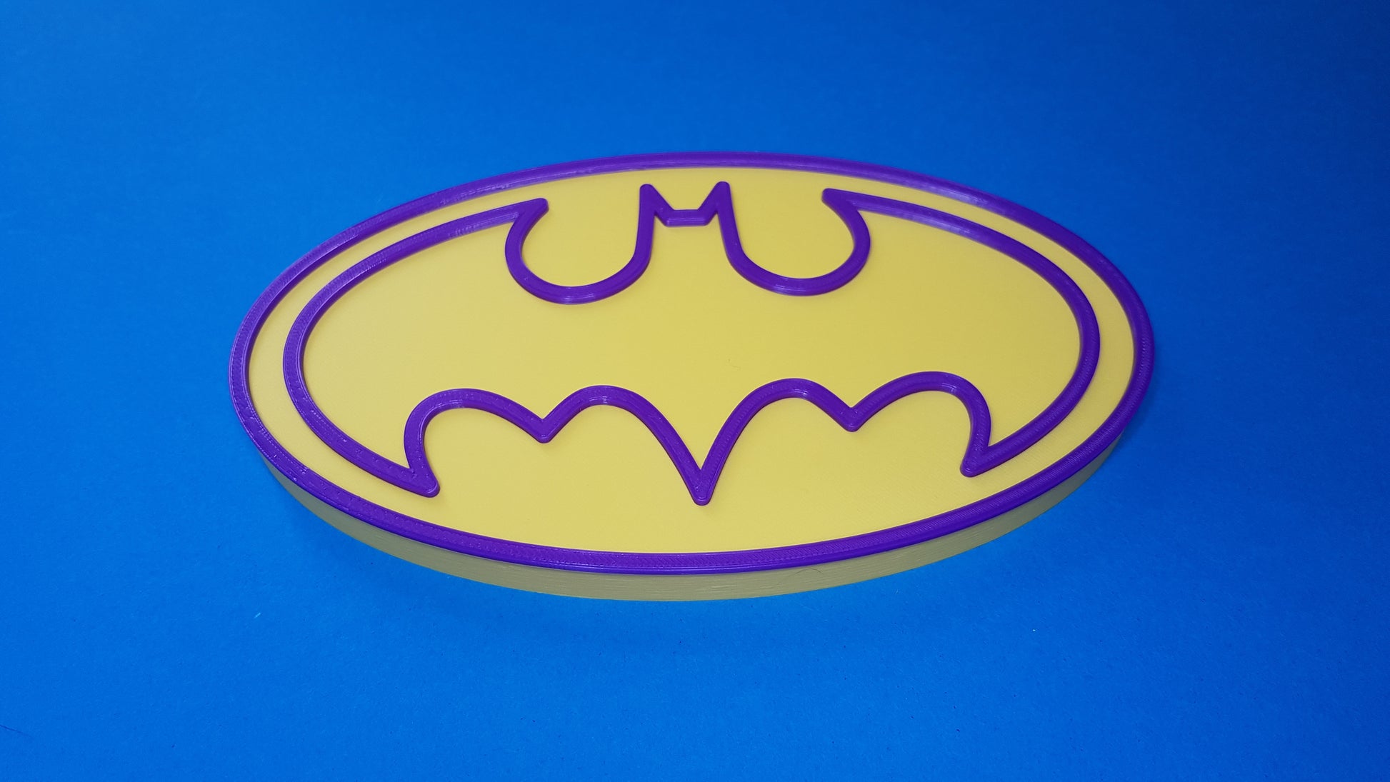 Batgirl logo on a blue background
