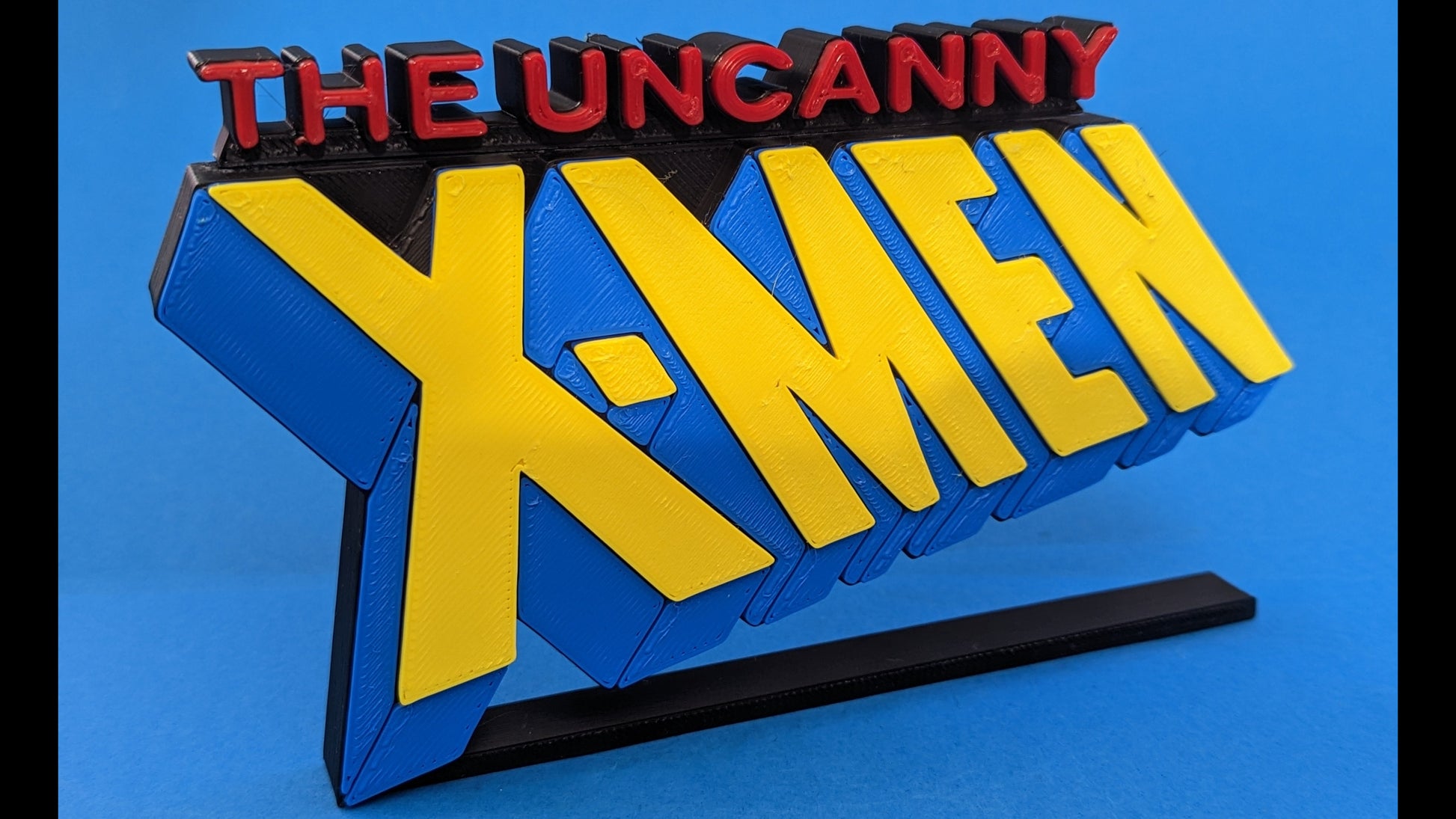 3D logo of 'The Uncanny X-Men' on a blue background