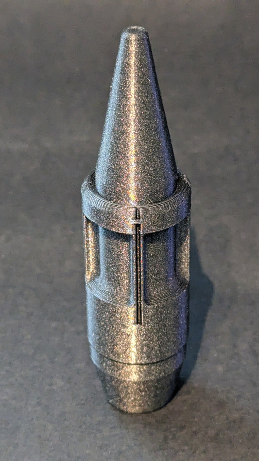 Metallic cone-shaped object on a gray background