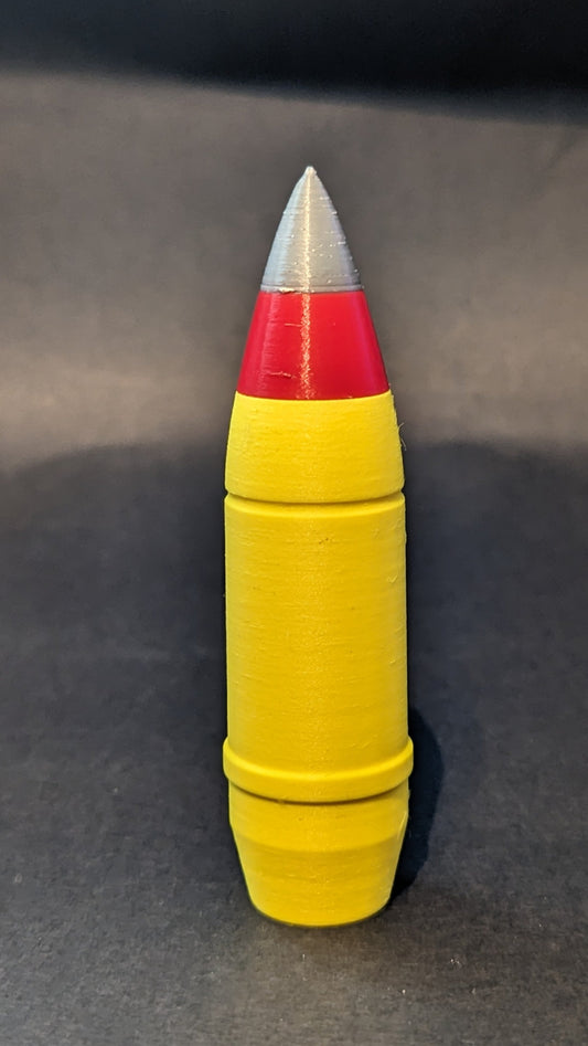 Yellow cylindrical object with red and silver top on a gray background