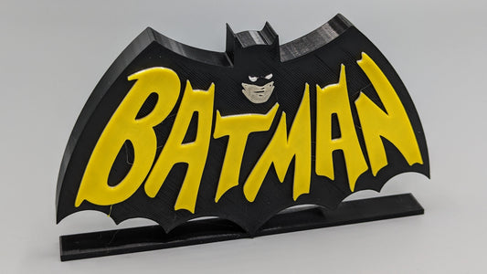 Batman logo with yellow text on a black background