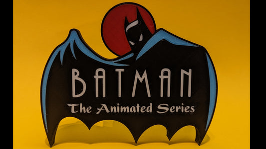 Batman logo from 'The Animated Series' on a yellow background