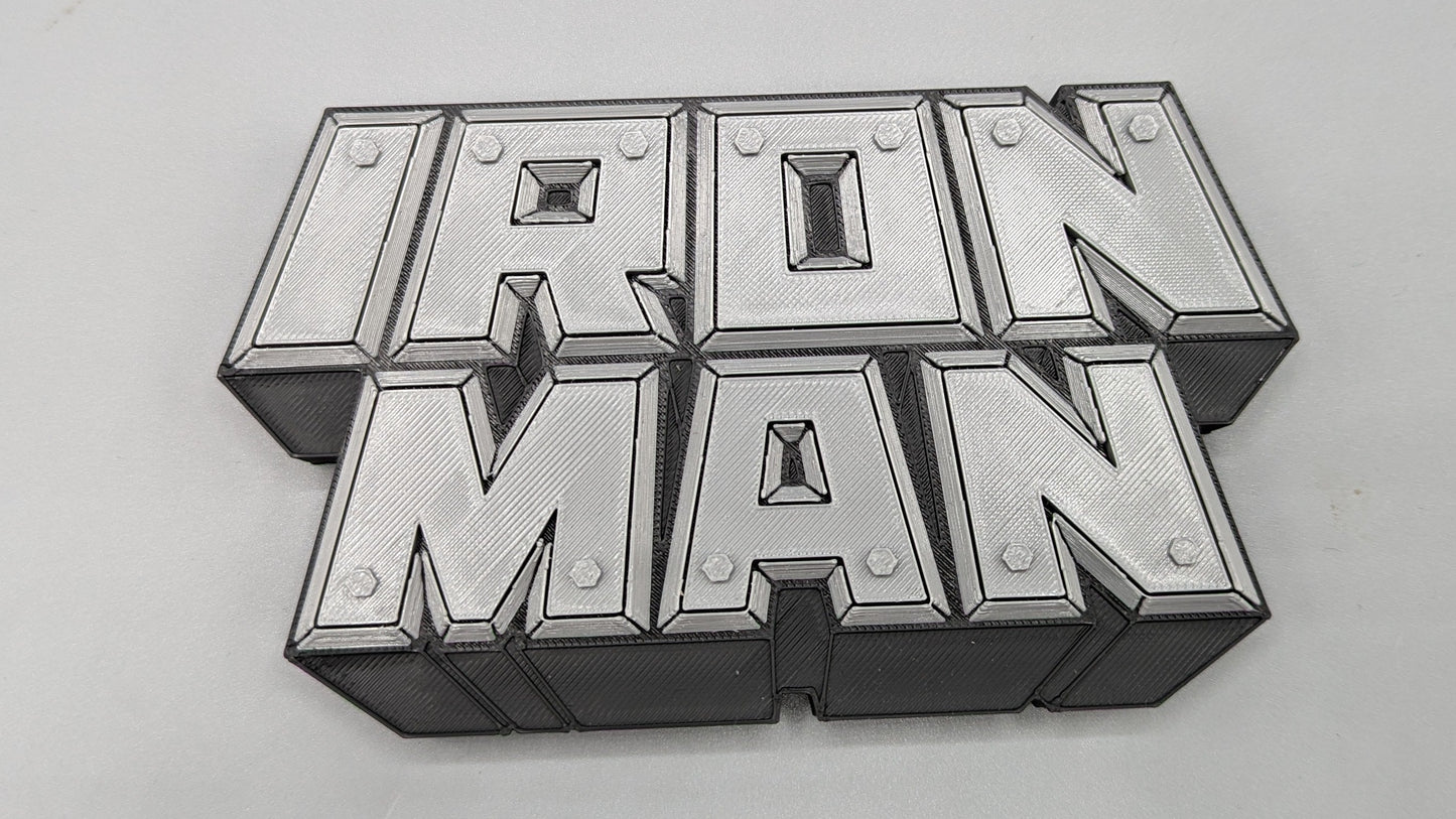 Metallic 'Iron Man' logo on a gray background