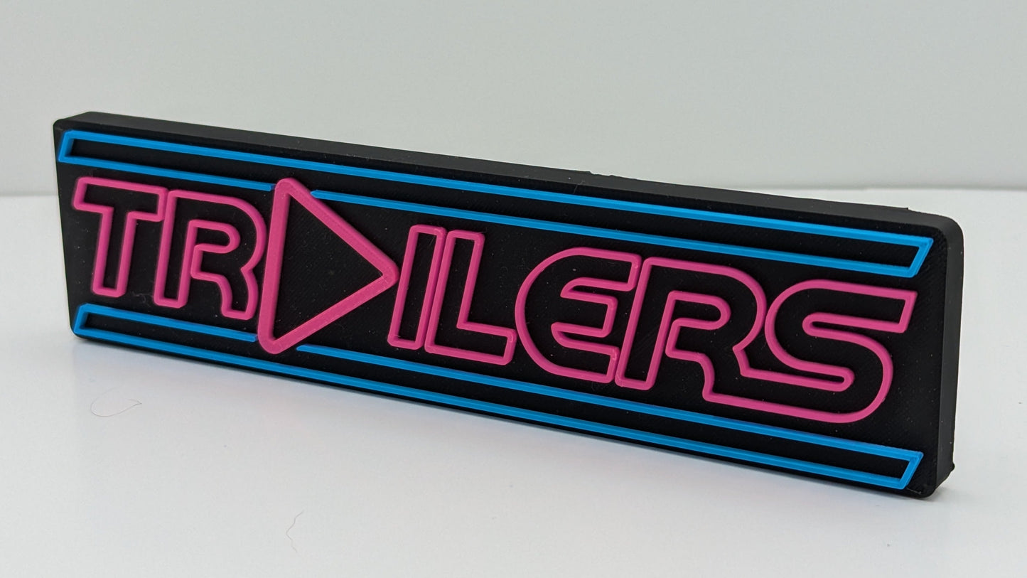 Neon sign with 'TRAILERS' text on a white background