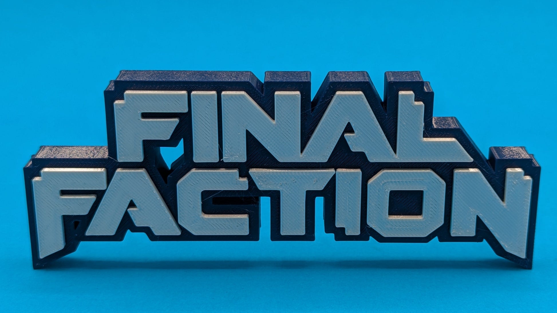 3D printed 'FINAL FACTION' logo on a blue background