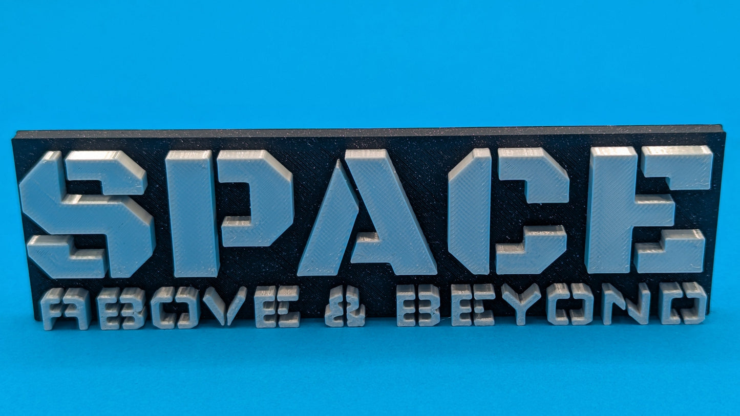 Metallic 'SPACE ABOVE & BEYOND' sign on a blue background