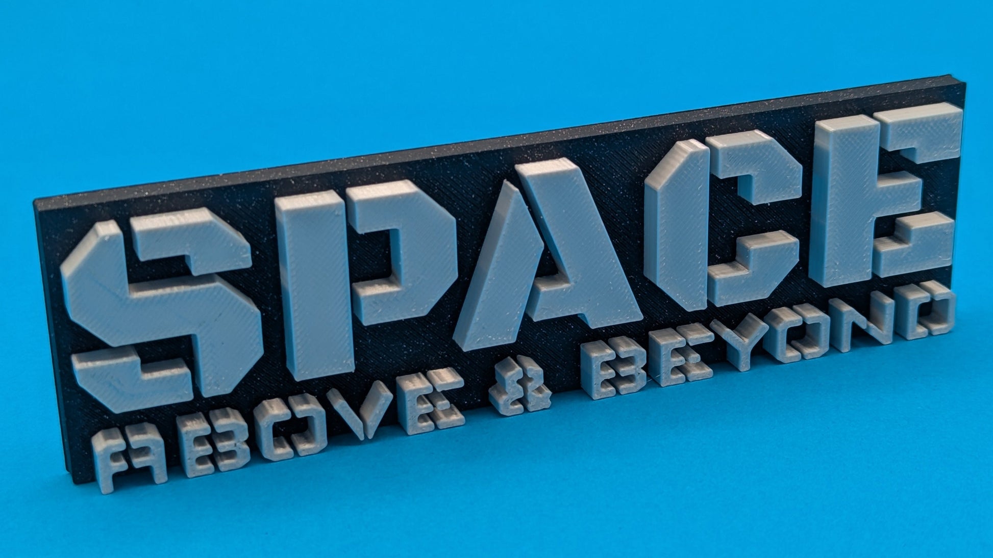 3D metal sign with 'SPACE ABOVE & BEYOND' text on a blue background