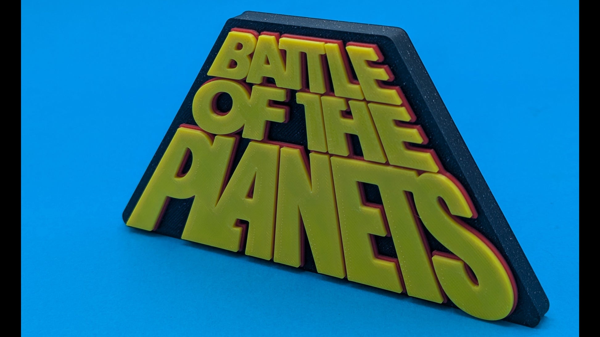 Triangular sign with 'Battle of the Planets' text on a blue background