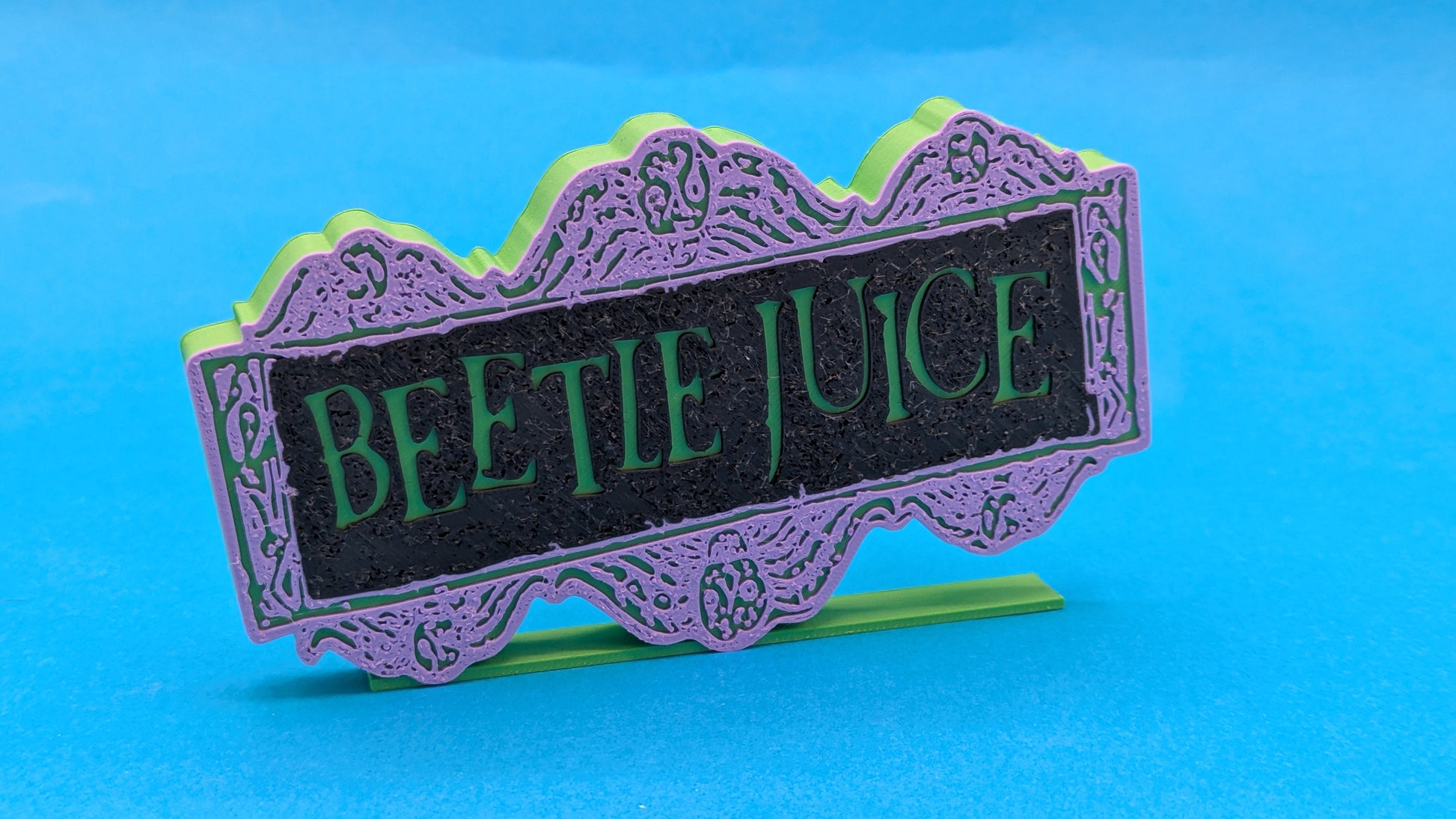 Decorative sign with 'Beetle Juice' text on a blue background