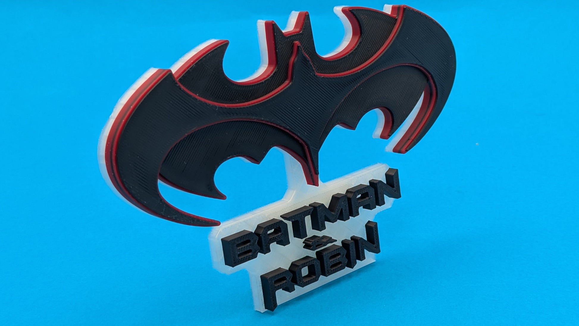 Batman and Robin logo on a blue background