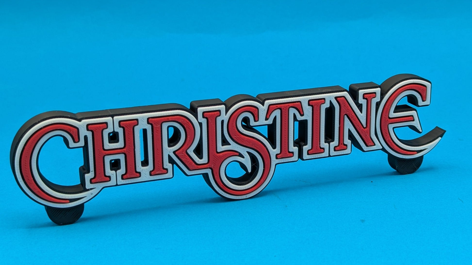 Decorative sign with 'CHRISTINE' on a blue background