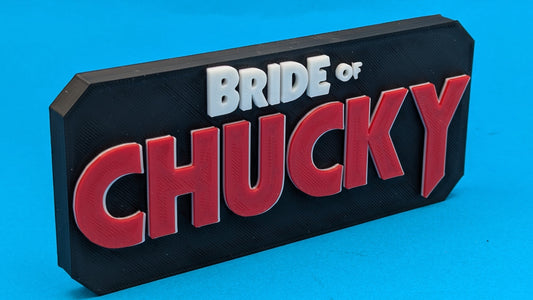 Decorative sign with 'Bride of Chucky' text on a blue background