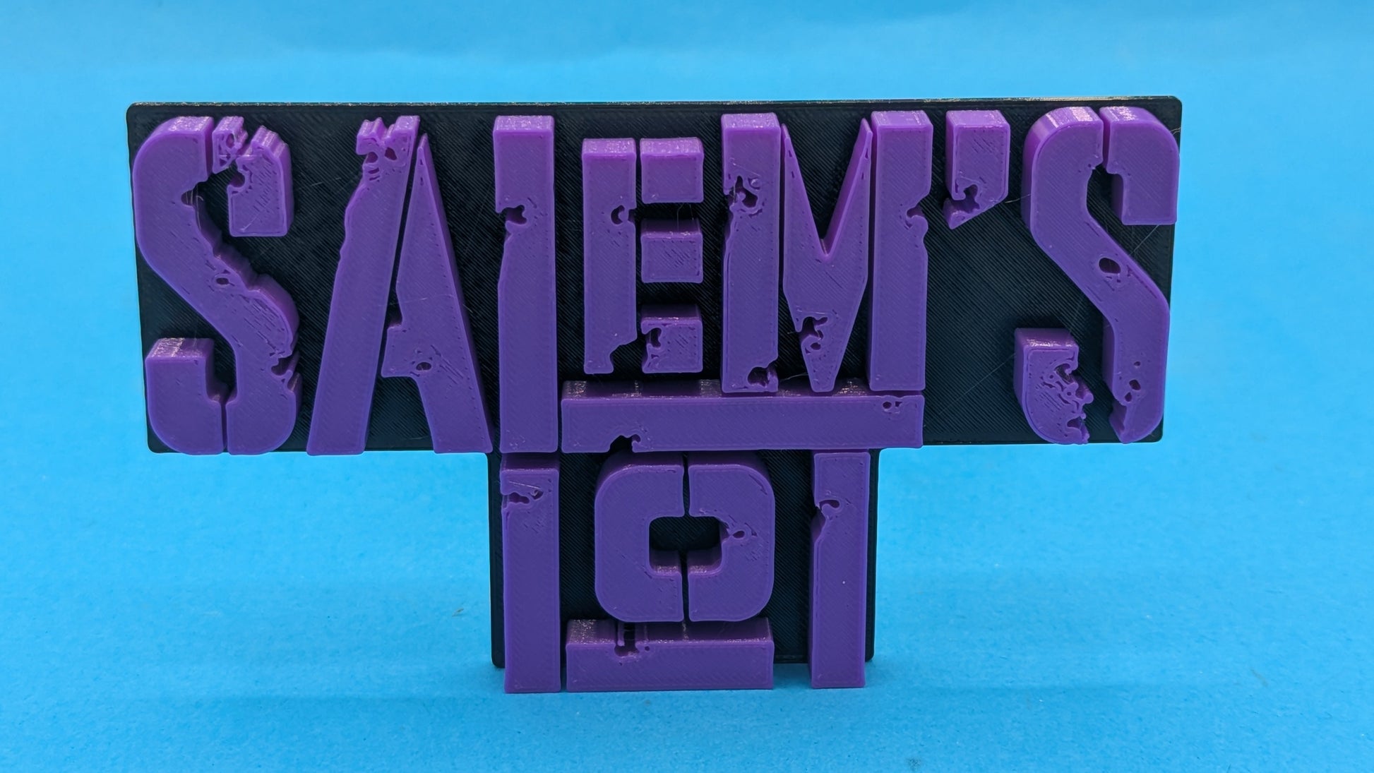 Purple 'Salem's Lot sign on a blue background