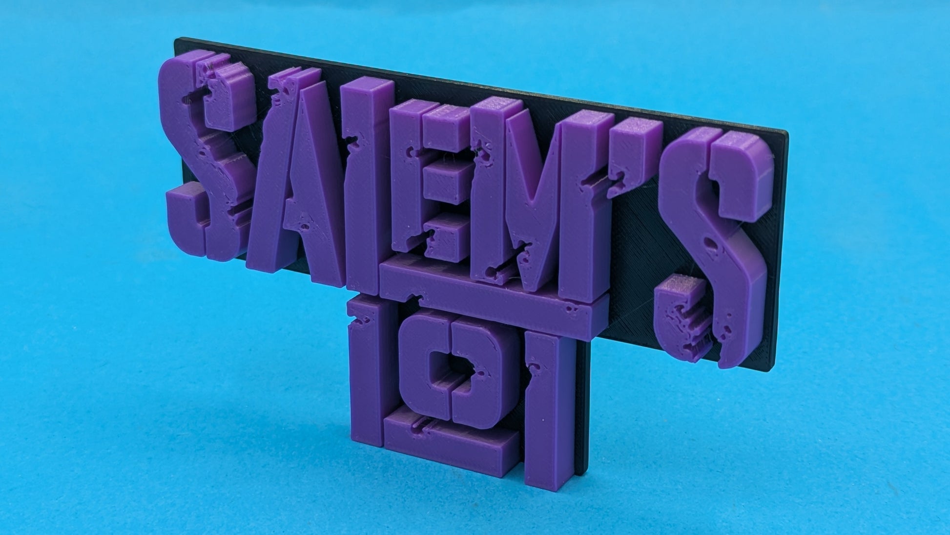 Purple 'Salem's Lot' sign on a blue background