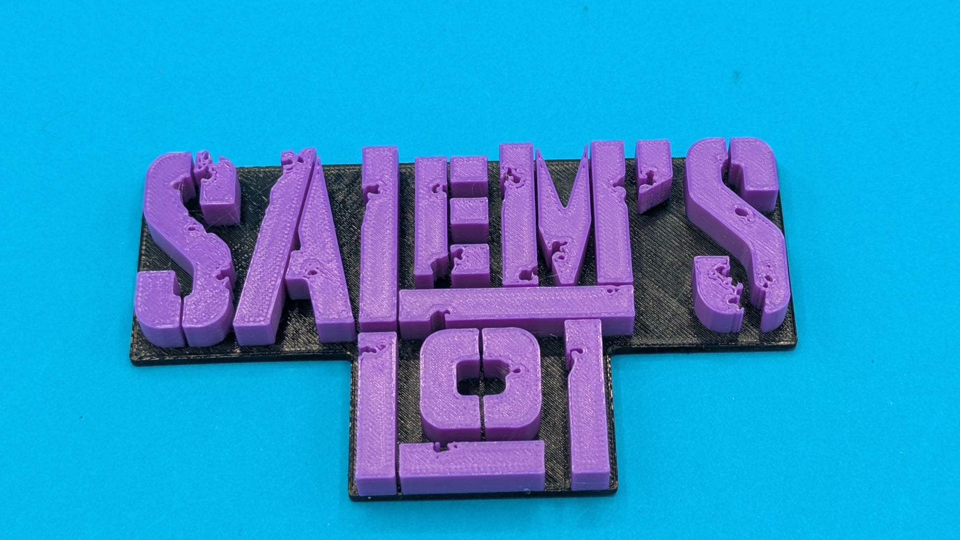 Purple 'Salem's Lot sign on a blue background
