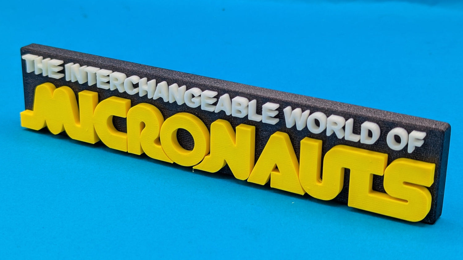 Logo of 'The Interchangeable World of Micronauts' on a blue background