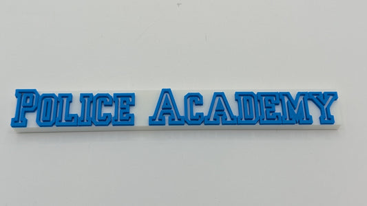 Blue 'POLICE ACADEMY' text on a white background