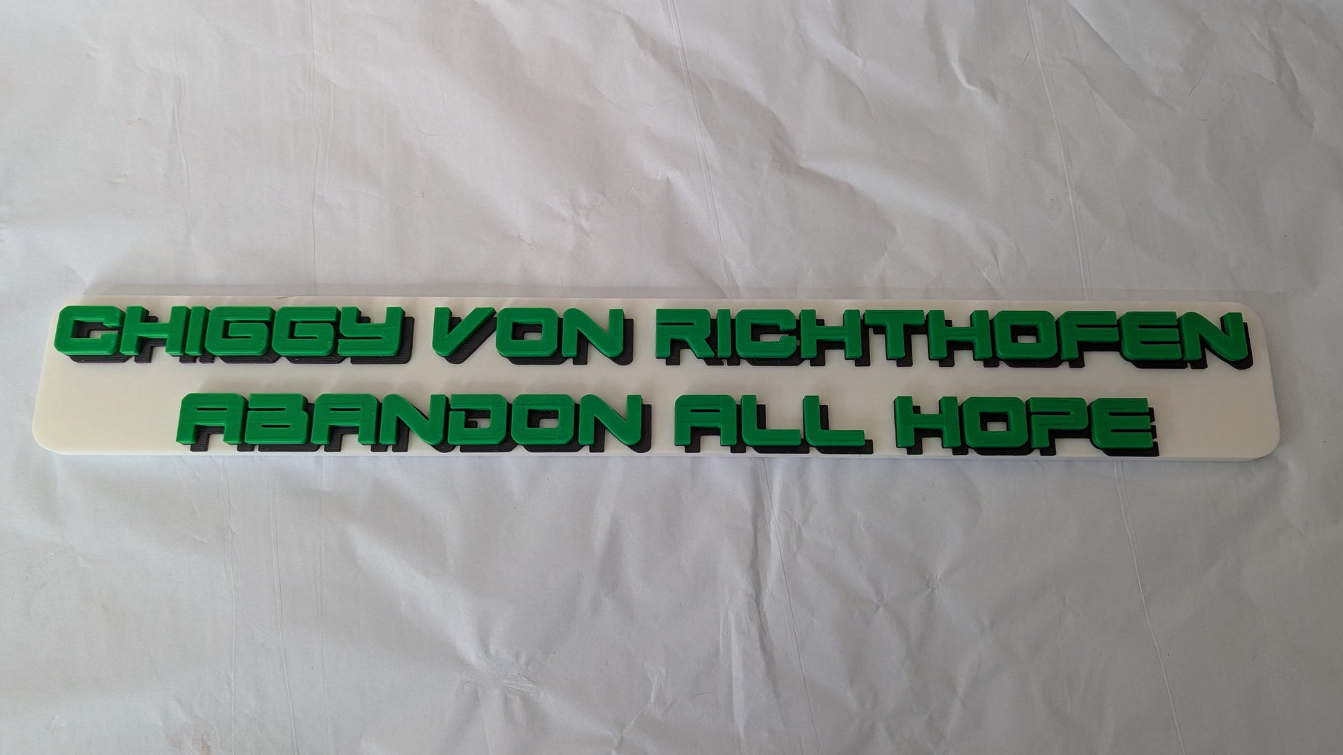 Text decal with 'Chiggy von Richthoven Abandon All Hope' on a white background