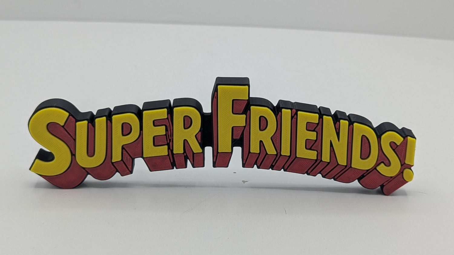 3D printed 'Super Friends!' logo on a white background