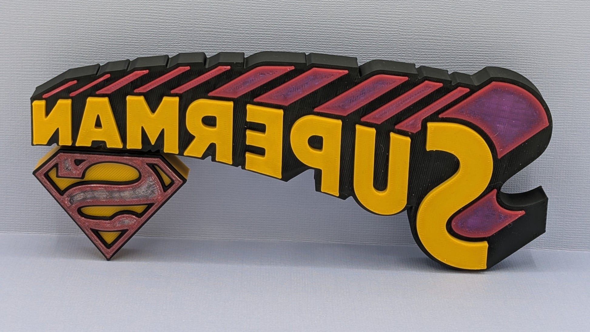 Superman logo and text on a white background