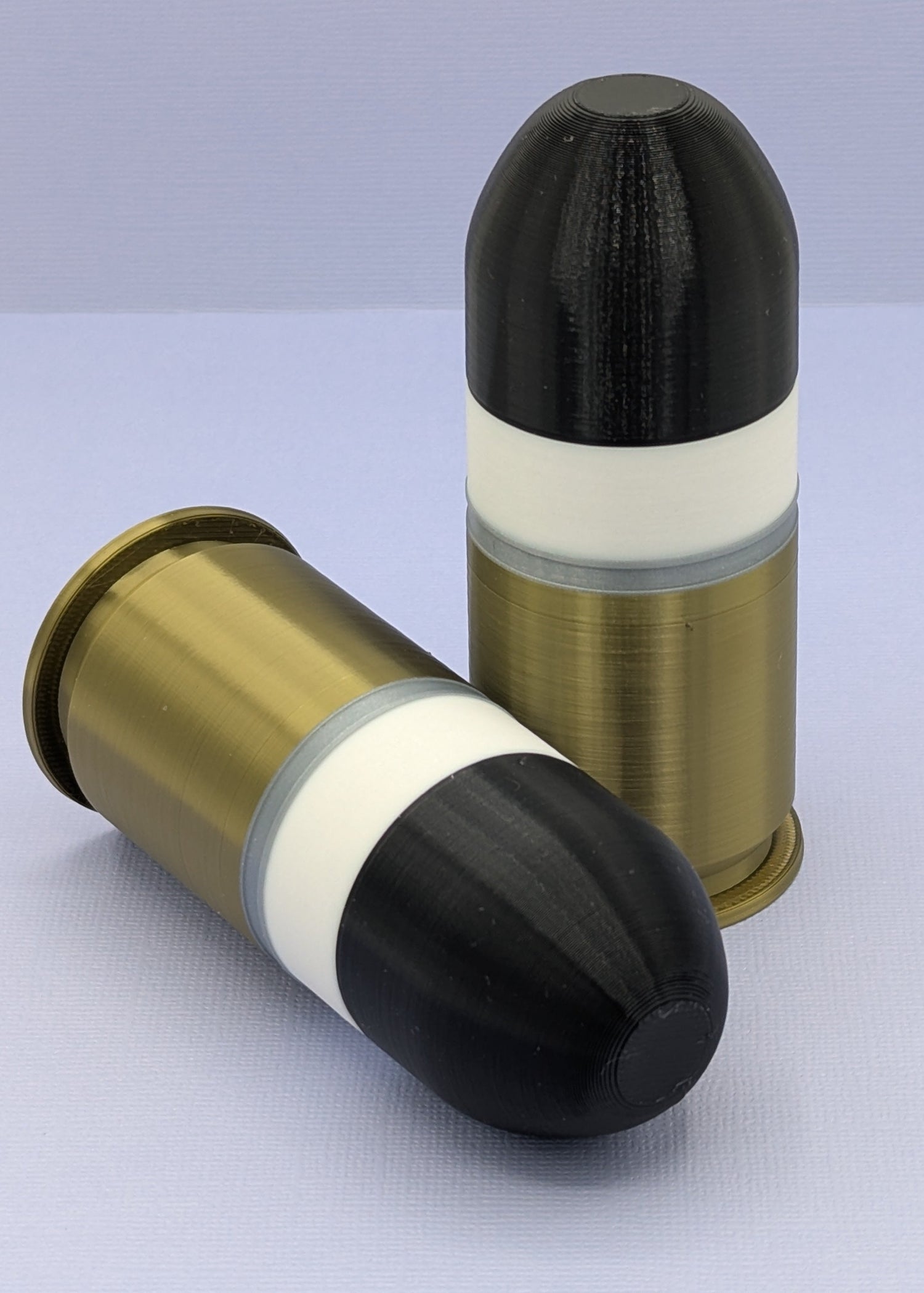 Two bullet casings on a light gray background