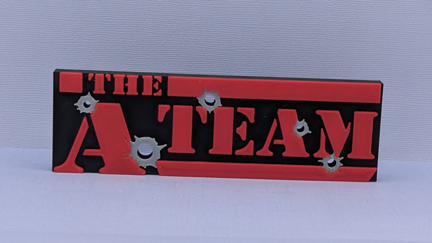 Decorative sign with 'The A Team' text on a plain background