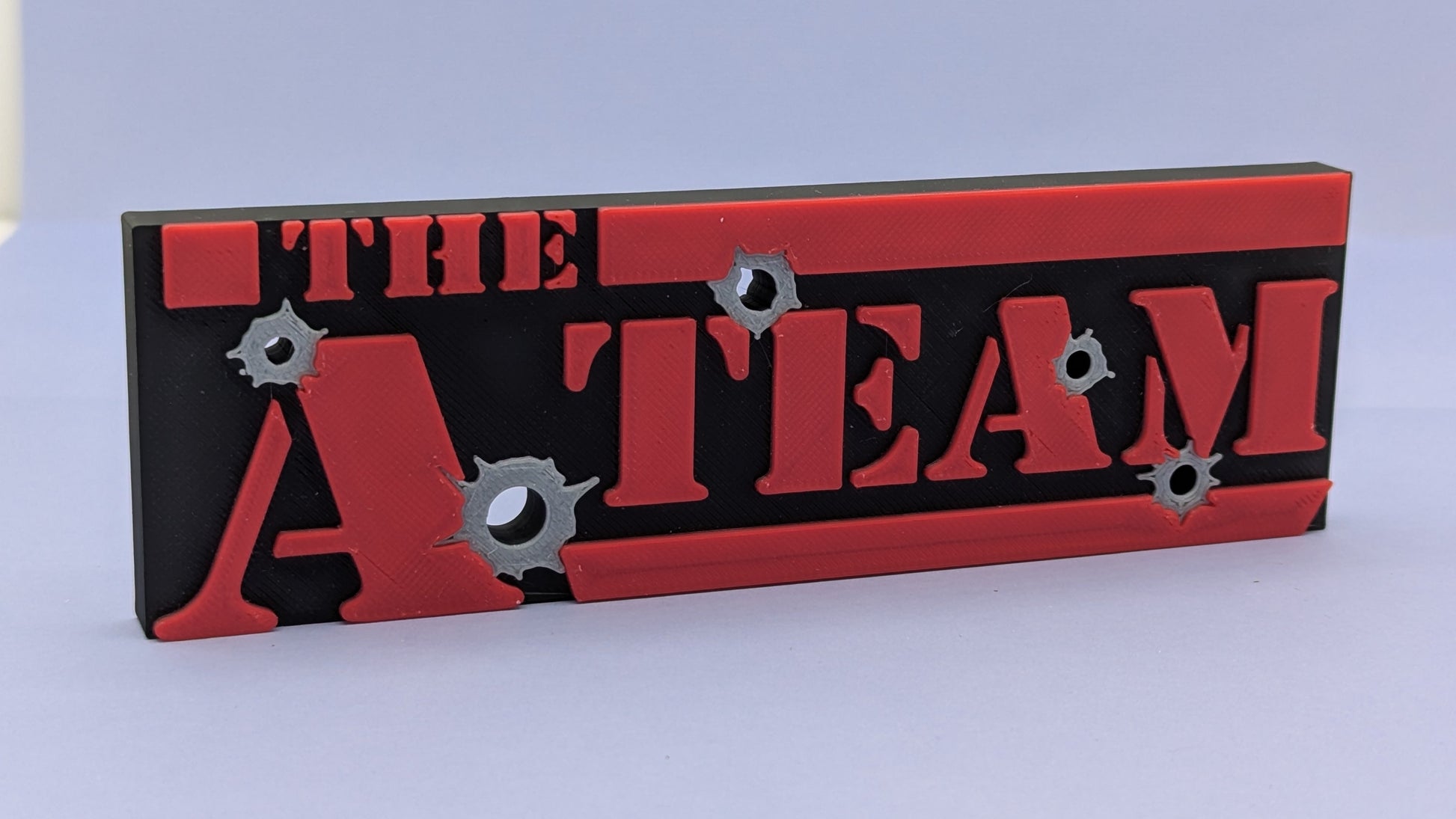 Decorative sign with 'The A Team' text on a red and black background