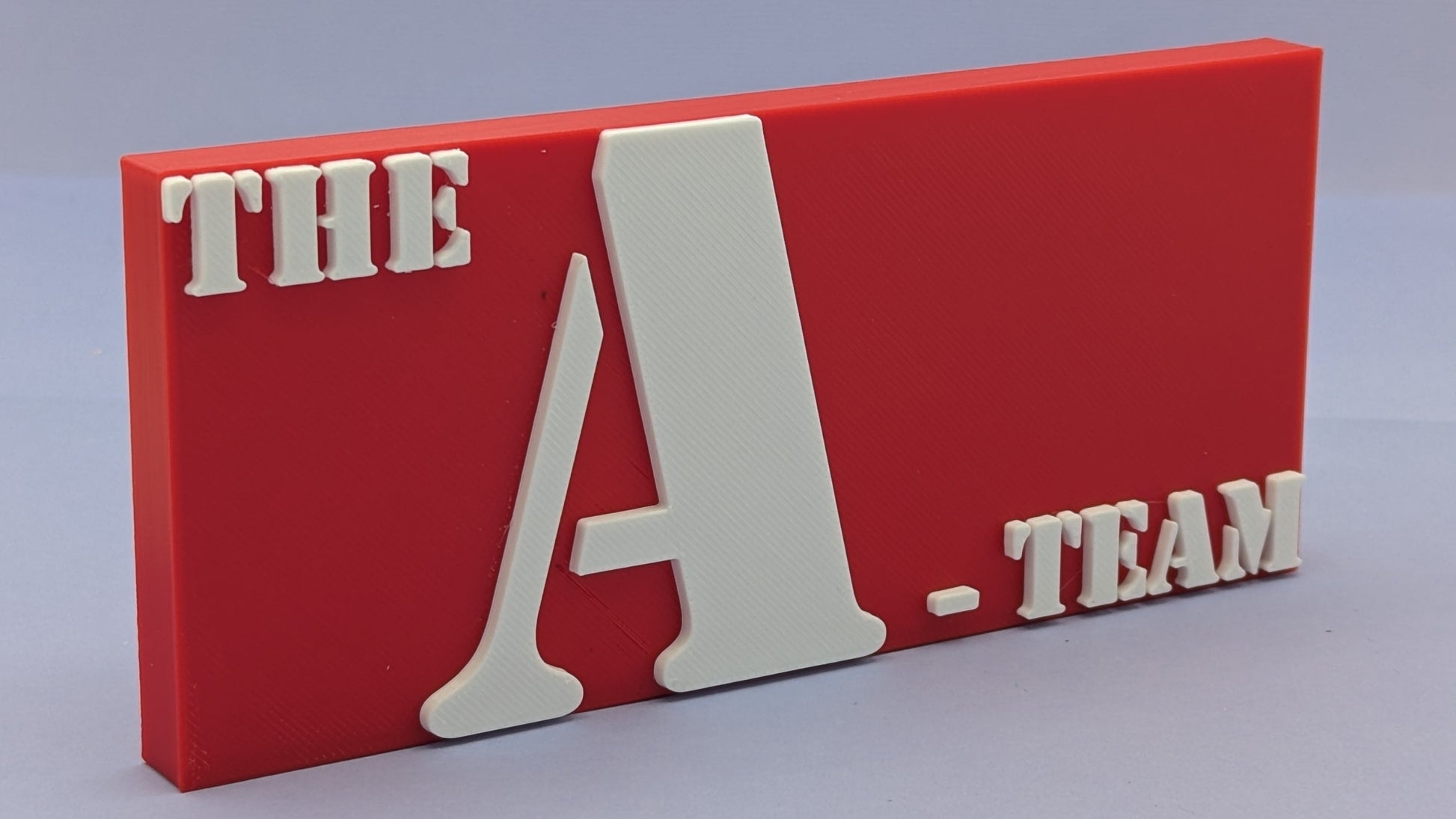 Red sign with 'THE A-TEAM' text on a gray background
