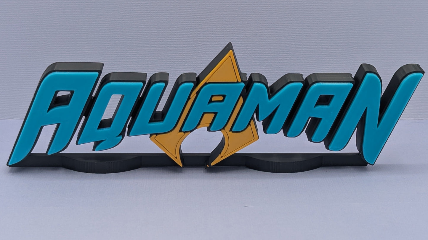 Aquaman logo with blue and black text on a gray background