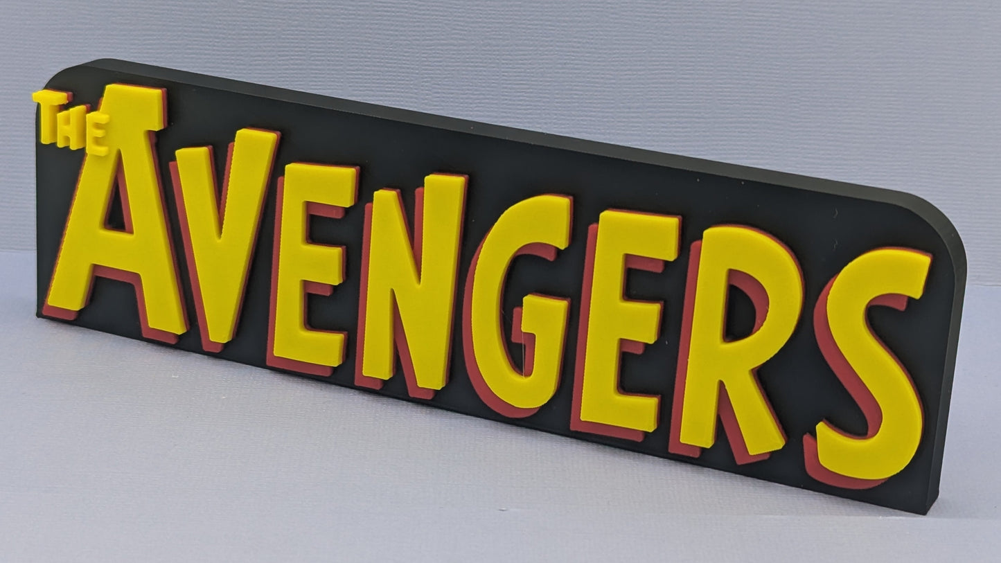 Decorative sign with 'The Avengers' text on a plain background