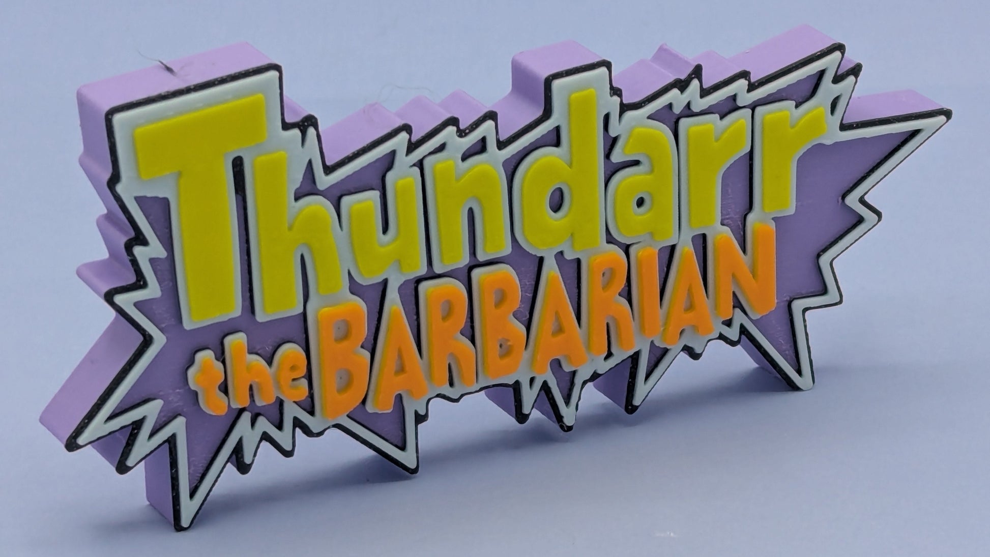 3D logo of 'Thundarr the Barbarian' with a purple border on a light blue background