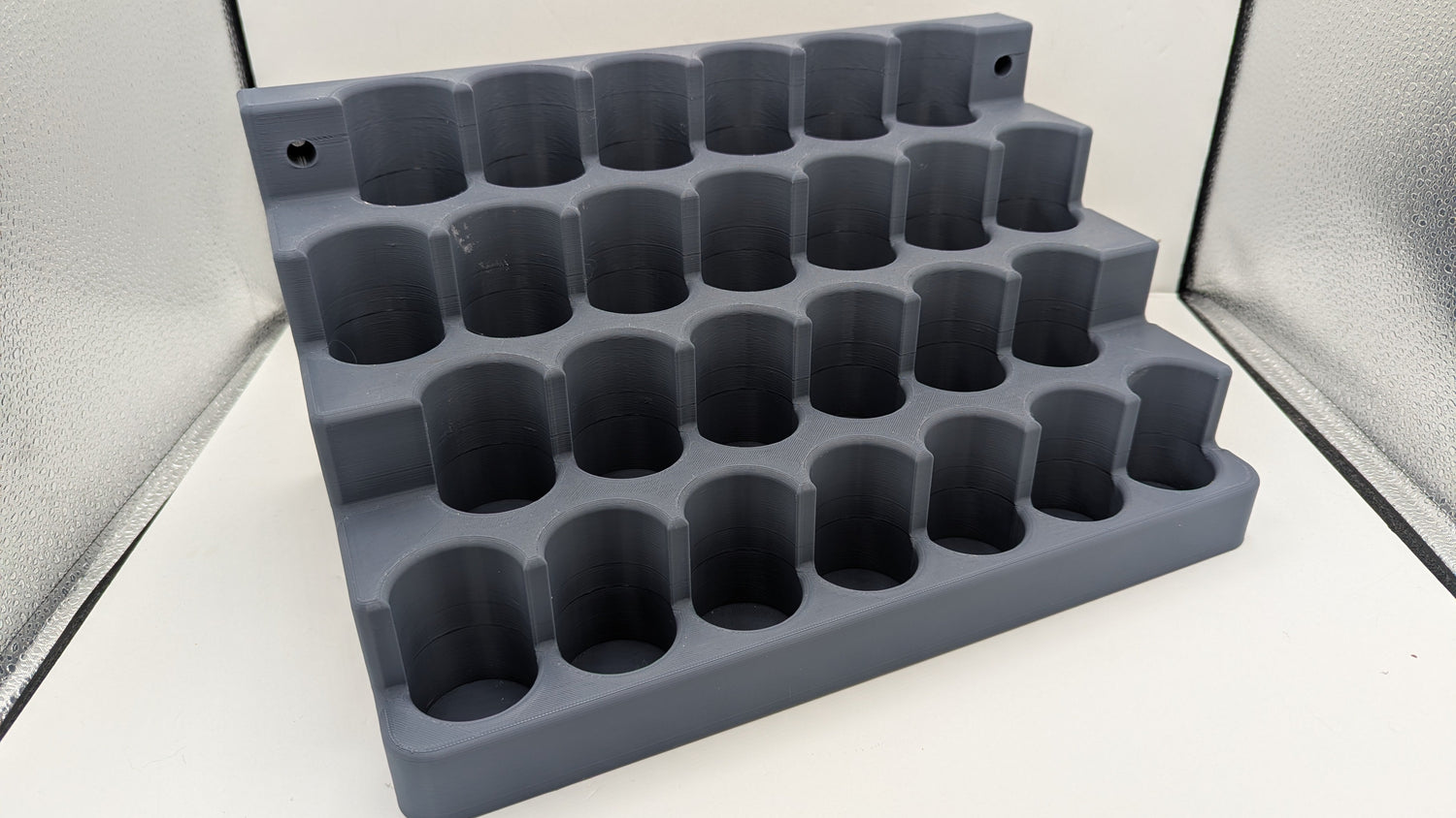 Gray silicone mold with multiple cavities on a white background