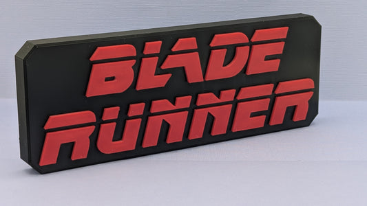 Black and red 'Blade Runner' sign on a light gray background